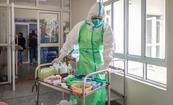 A healthcare worker in Kenya prepares Ebola response materials as part of a training exercise.